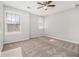 A bright bedroom featuring neutral walls, carpet floors, a ceiling fan, and natural light from two windows at 4319 Alysheba Dr, Fairburn, GA 30213