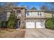 Charming two-story home with a stone facade, two-car garage, and well-maintained landscaping at 4319 Alysheba Dr, Fairburn, GA 30213