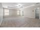 Large main bedroom with neutral carpet, tray ceiling, ceiling fan, and a walk-in closet at 4319 Alysheba Dr, Fairburn, GA 30213