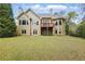 Expansive backyard featuring a large lawn, mature trees, and a cozy deck, ideal for outdoor living at 627 Warsaw Rd, Roswell, GA 30075