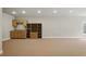 A spacious carpeted basement with custom cabinets and a wet bar at 627 Warsaw Rd, Roswell, GA 30075