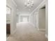 A spacious basement with neutral carpet, recessed lighting, and a chandelier at 627 Warsaw Rd, Roswell, GA 30075