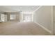 A spacious basement with neutral carpet, recessed lighting, and double glass doors at 627 Warsaw Rd, Roswell, GA 30075
