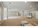 A spacious basement featuring columns, recessed lighting and neutral carpet at 627 Warsaw Rd, Roswell, GA 30075