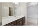 Bathroom featuring a single sink vanity with dark wood cabinets and a large mirror at 627 Warsaw Rd, Roswell, GA 30075