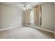 Bedroom with a ceiling fan, plush carpeting, and curtains covering a window at 627 Warsaw Rd, Roswell, GA 30075