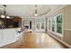 Breakfast nook with bar seating and many windows providing natural light and backyard views at 627 Warsaw Rd, Roswell, GA 30075