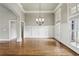Elegant dining room features hardwood floors, wainscoting, and a stylish chandelier at 627 Warsaw Rd, Roswell, GA 30075