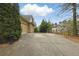 Wide driveway leads to a home with a side-entry garage and well-manicured landscaping at 627 Warsaw Rd, Roswell, GA 30075