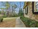 Exterior of home with stone and siding details, lush landscaping, and a winding walkway at 627 Warsaw Rd, Roswell, GA 30075