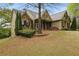 Charming exterior of home featuring stone accents, a well-manicured lawn, and mature landscaping at 627 Warsaw Rd, Roswell, GA 30075