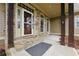 Inviting front porch with stone accents, wood columns, and a welcoming entrance door at 627 Warsaw Rd, Roswell, GA 30075