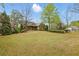 Inviting front yard with lush lawn and mature trees, showcasing the home's curb appeal at 627 Warsaw Rd, Roswell, GA 30075