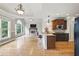 Open kitchen and living area with granite countertops and stainless steel appliances at 627 Warsaw Rd, Roswell, GA 30075