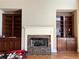 Cozy living room with built-in bookshelves and a marble fireplace, perfect for relaxation and entertainment at 627 Warsaw Rd, Roswell, GA 30075