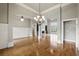 Open-concept living room with hardwood floors, arched doorways, and natural light at 627 Warsaw Rd, Roswell, GA 30075