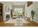 Bright living room boasts large windows, a fireplace, and hardwood floors at 627 Warsaw Rd, Roswell, GA 30075