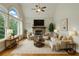 Inviting living room with stone fireplace and large arched windows provides an abundance of natural light at 627 Warsaw Rd, Roswell, GA 30075