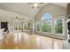 Bright open living space with hardwood floors, a cozy fireplace, and access to the outdoor deck at 627 Warsaw Rd, Roswell, GA 30075
