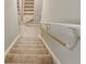 Carpeted staircase featuring a handrail and white trim at 627 Warsaw Rd, Roswell, GA 30075