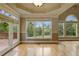 Bright sunroom with hardwood floors, large windows, and deck access at 627 Warsaw Rd, Roswell, GA 30075