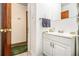 A full bathroom featuring a vanity, sink, and a metal towel rack near the doorway at 640 Maple Dr, Riverdale, GA 30274