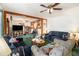 Comfortable living room with wood beam accents, ceiling fans, and ample seating for gatherings at 640 Maple Dr, Riverdale, GA 30274