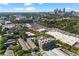 An aerial view of a neighborhood with mature trees and a city skyline in the distance at 818 Highland Green Ne Way # 818, Atlanta, GA 30306