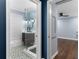 Bathroom featuring a glass shower, wood vanity with a black faucet, and designer tile at 818 Highland Green Ne Way # 818, Atlanta, GA 30306