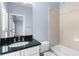 Bathroom features a dark granite countertop with a white sink and matching cabinets at 818 Highland Green Ne Way # 818, Atlanta, GA 30306