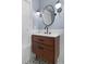 Bathroom featuring wood vanity with an oval mirror, black faucet, and designer tile at 818 Highland Green Ne Way # 818, Atlanta, GA 30306