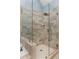 Bathroom featuring a frameless glass shower with rainfall shower head and tiled walls at 818 Highland Green Ne Way # 818, Atlanta, GA 30306