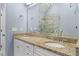 Bathroom with double vanity sinks, granite countertops, and a frameless glass shower in the mirror reflection at 818 Highland Green Ne Way # 818, Atlanta, GA 30306