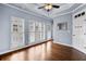 Bright bedroom with plantation shutters, hardwood floors, a ceiling fan, and tray ceiling at 818 Highland Green Ne Way # 818, Atlanta, GA 30306