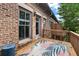Outdoor deck with brick home exterior features an area rug, wood railings and a view at 818 Highland Green Ne Way # 818, Atlanta, GA 30306