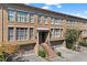 Charming townhome featuring a brick facade, covered entry, and attached garage at 818 Highland Green Ne Way # 818, Atlanta, GA 30306