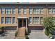 Charming townhome featuring a brick facade, covered entry, and attached garage at 818 Highland Green Ne Way # 818, Atlanta, GA 30306