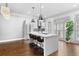 Spacious kitchen boasts a center island with seating, stainless steel appliances, and generous natural light from window shutters at 818 Highland Green Ne Way # 818, Atlanta, GA 30306