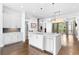 Open-concept kitchen features an island with stainless steel dishwasher and sink, seamlessly flowing into the adjacent living spaces at 818 Highland Green Ne Way # 818, Atlanta, GA 30306