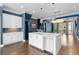 Stylish kitchen features an island with stainless steel dishwasher and sink, flowing into adjacent living area, with white cabinets at 818 Highland Green Ne Way # 818, Atlanta, GA 30306