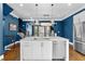 Bright kitchen features an island with stainless steel dishwasher and sink, flowing into adjacent living area, with white cabinets at 818 Highland Green Ne Way # 818, Atlanta, GA 30306