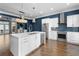 Modern kitchen boasts stainless steel appliances, white cabinets, and a stylish backsplash, complemented by natural light from adjacent room at 818 Highland Green Ne Way # 818, Atlanta, GA 30306