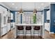 Bright kitchen boasts a center island with seating, stainless steel appliances, and generous natural light from window shutters at 818 Highland Green Ne Way # 818, Atlanta, GA 30306