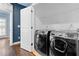 Laundry room showcases a modern washer and dryer, with wire shelving for optimal storage at 818 Highland Green Ne Way # 818, Atlanta, GA 30306