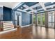 Open living room with coffered ceiling, hardwood floors, and stairs at 818 Highland Green Ne Way # 818, Atlanta, GA 30306