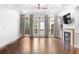 Bright living room with hardwood floors, a fireplace, and doors to the deck at 818 Highland Green Ne Way # 818, Atlanta, GA 30306