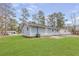 A well-maintained backyard featuring a lush green lawn and the exterior of the home at 8199 Cousins St, Douglasville, GA 30134