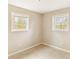 Bright bedroom with two windows, neutral walls, and light-colored flooring at 8199 Cousins St, Douglasville, GA 30134