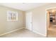 Bedroom with light walls, a window and connecting door to other rooms at 8199 Cousins St, Douglasville, GA 30134