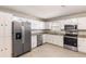 Updated kitchen with stainless steel appliances, white cabinetry, and granite countertops at 8199 Cousins St, Douglasville, GA 30134